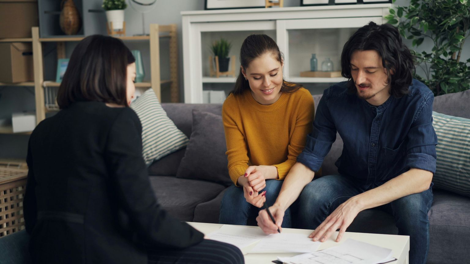 Central Coast couple reviewing home loan options with mortgage broker in a relaxed home setting