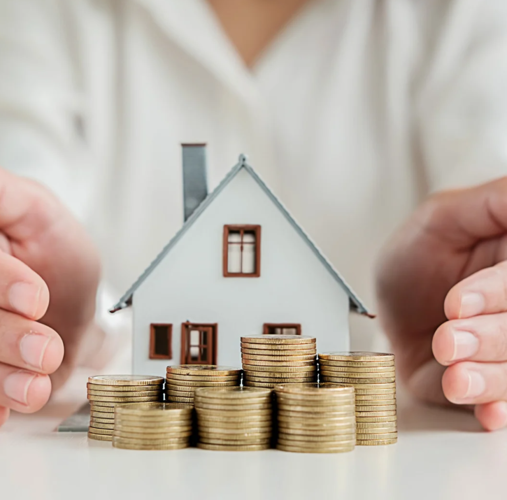 Small house with gold coins in front and hands wrapped around symbolising SMSF property investment protection