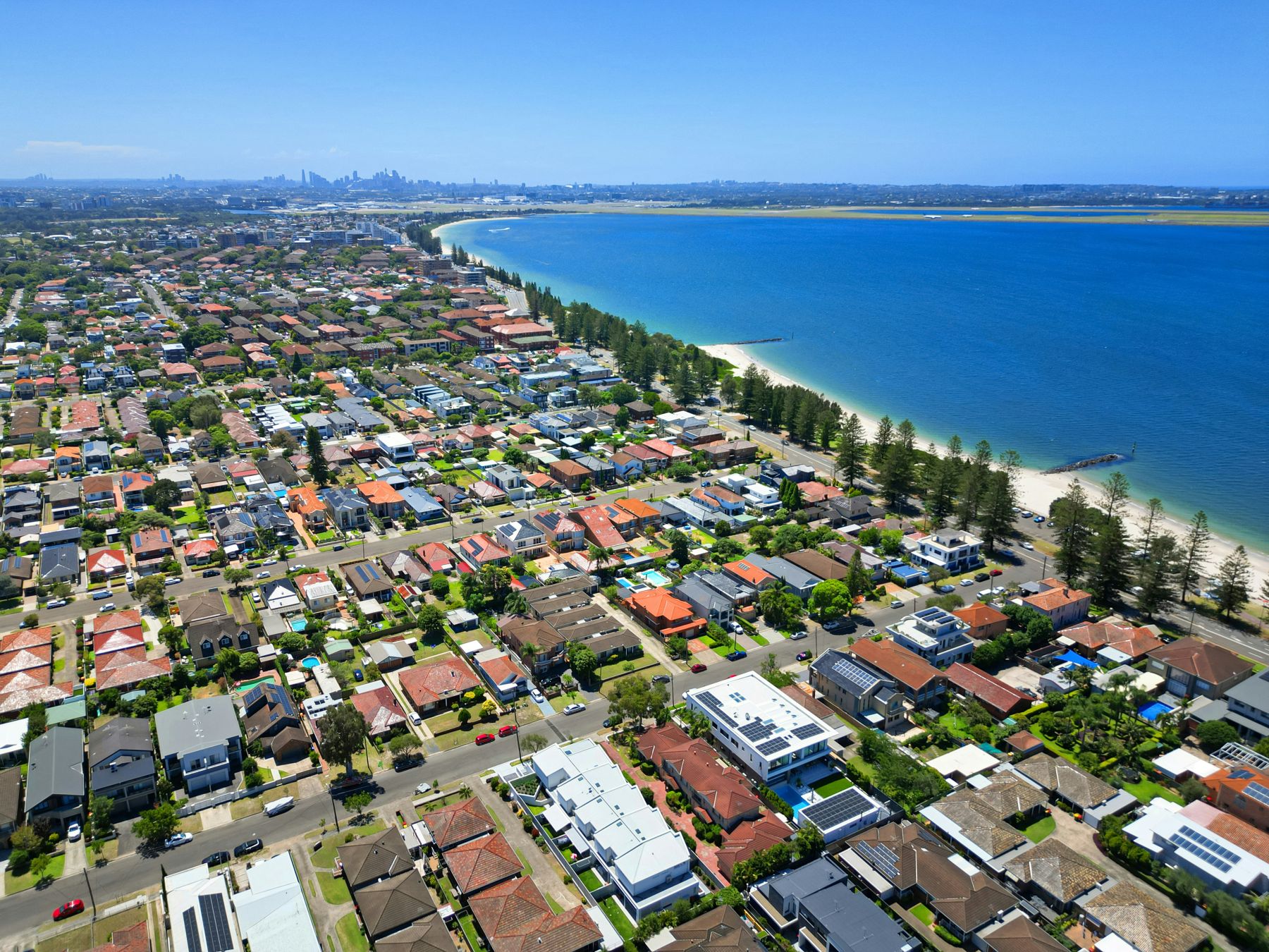 Aerial view of a Central Coast beachside suburb showing homes near the coast, representing local property and home loan opportunities in 2025.