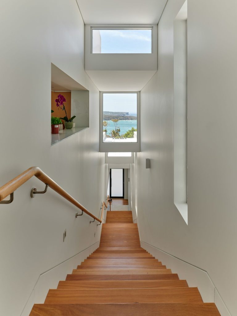 Wooden staircase leading toward elevated water views along the coast.