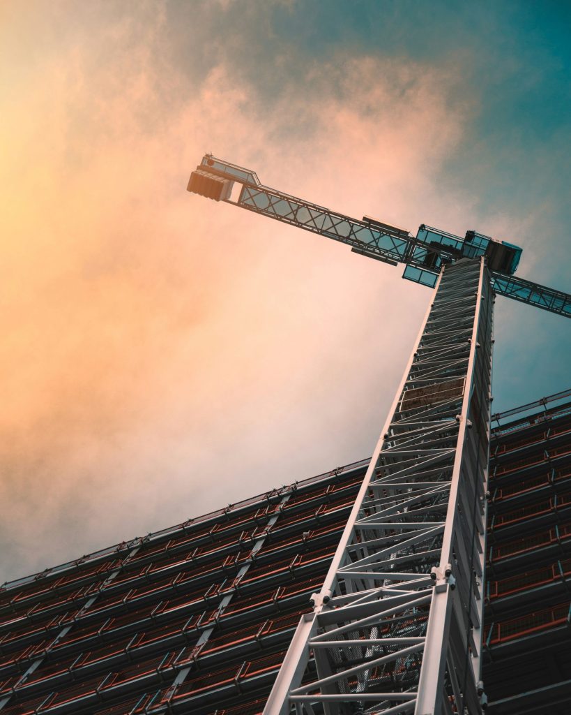 Construction crane lifting materials at residential building site Central Coast