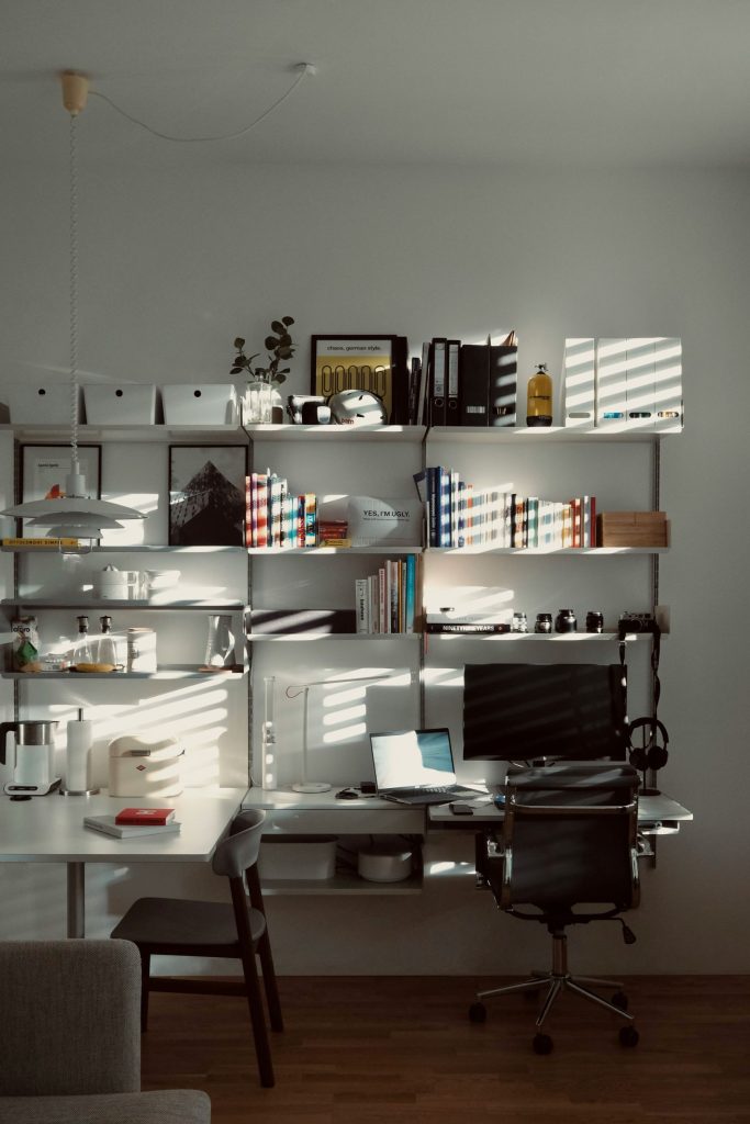 Organised desk with financial documents, calculator and laptop.