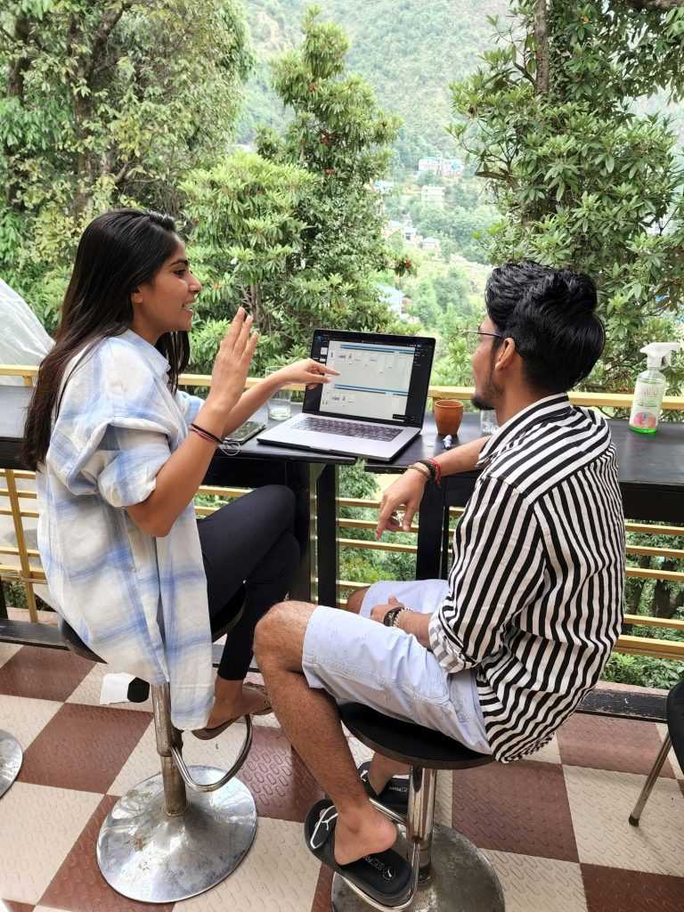 Couple reviewing documents on a laptop in a home office.
