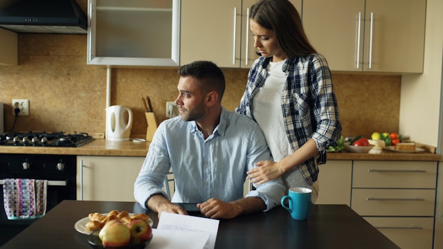 Australian couple reviewing finances at home ahead of Federal Budget 2026 housing and mortgage changes
