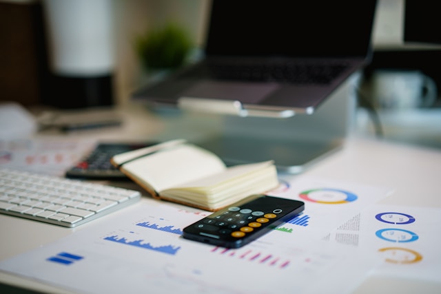 Financial documents, calculator and notebook used to review existing debts before a home loan application